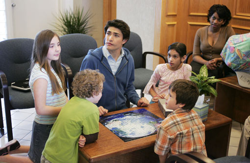 Kyle, putting a puzzle together