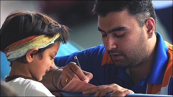 India's Gagan Narang signs autographs