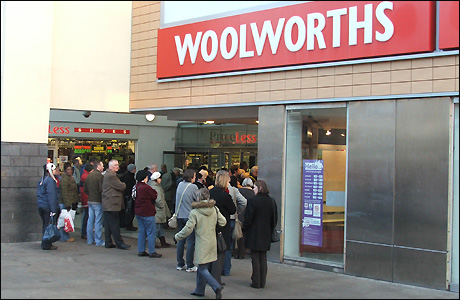 Shoppers wait for the shop to open