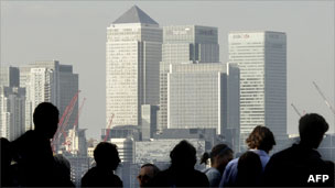 People walking in front of the Canary Wharf skyline