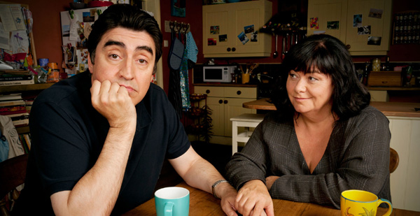 Roger and Val sitting at the kitchen table.