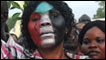 A woman with the Sudanese flag painted on her face