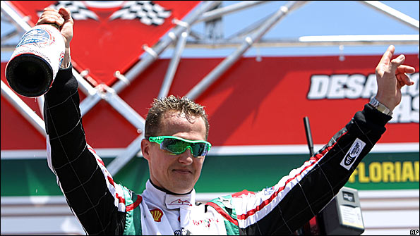 Michael Schumacher celebrates on the podium at Felipe Massa's karting challenge last month
