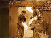 Couple in yard c/o Sutcliffe Gallery