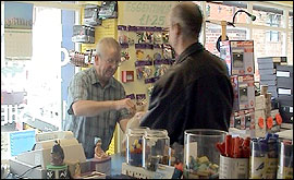 Alan Povey serves in his shop
