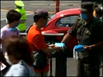 policeman hands out facemasks