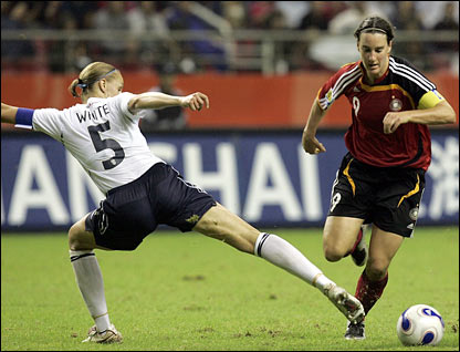 England's Faye White fights for the ball with German Birgit Prinz 