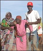 UNHCR aid workers assist refugees (image courtesy: UNHCR/H Caux)