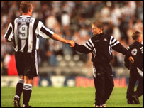Shearer shakes hand with the ball boy