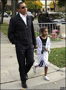 Barack Obama walks with his daughter Sasha in Chicago at Halloween