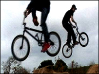 BMXers at jumps in St Ouen