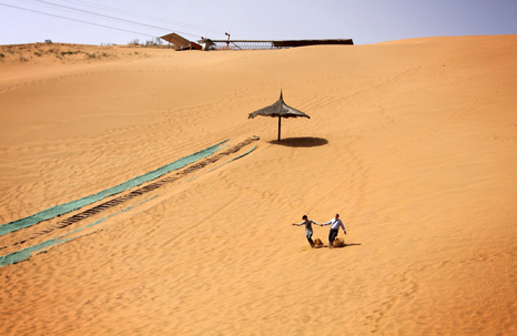 Tourists in the Shapotou Desert Theme Park in Ningxia Province. The area has been turned into a entertainment area for many domestic tourists who visit the region. 2009