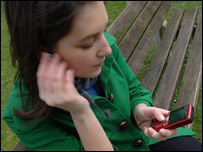 Woman using mobile to watch TV