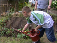 Joseph Murray waters the garden