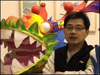 Chun Chao stands in front of his dragon