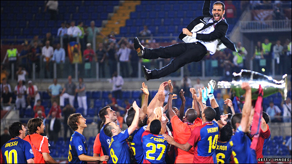 Barcelona players throw manager Pep Guardiola into the air