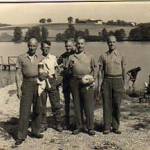 Photograph from Lieutenant James Patrick Heenan, Prisoner-of-War No.1106 (Oflag VIIC, Bataillon 2) Oflag VI — B Germany showing Lieutenant James Patrick Heenan to the right hand side of standing group of prisoners (Photograph by Dr. Jung)