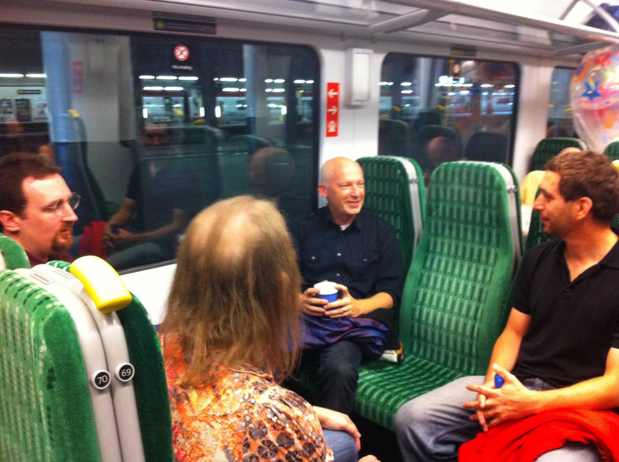 The three Code finalists on the train with Marcus du Sautoy