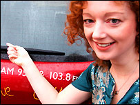 Frances Finn points at a car
