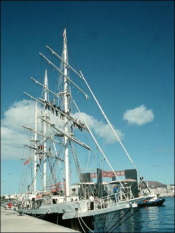 Ship at quayside with crew on its rigg