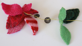 A garland made from leaf shapes, two buttons and some thread