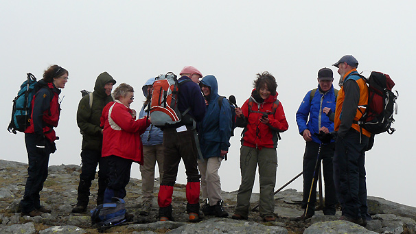 The goup reach the top of a windy Mayar.