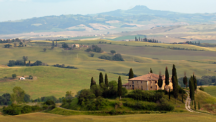 Tuscany, © BBC. A house on top of a hill surrounded by cypresses in Tuscany, Italy, 10/06/2008. Grass grasses cypress tree hill hills Italian landscape landscapes field fields Tuscan rural country