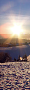 The rising sun illuminates snow-covered fields; from sxc.hu
