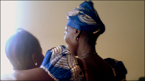 "MK (right of photo) greeted by an ex prisoner after her release" (photo © AdvocAid 2011) 