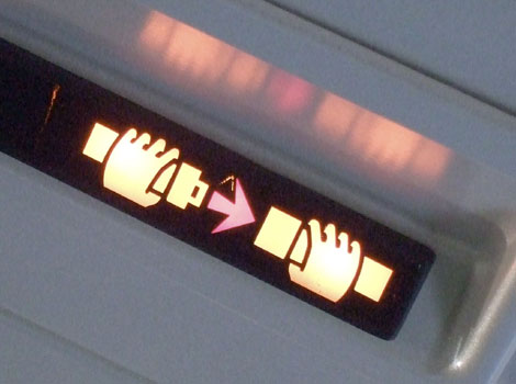 A 'fasten your seatbelt' sign on an aeroplane