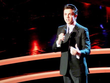 Ray Quinn, a young man in evening wear, singing alone on stage