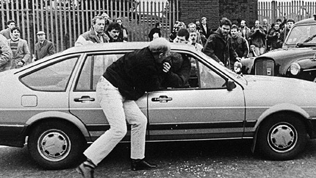 Corporal Derek Woods is pulled from his car at the funeral of Kevin Brady (Pacemaker Press Intl)