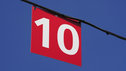 A 'ten' sign suspended from a wire