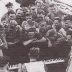 Men of the Highland Division have a sing-song on the deck of Sicily-bound HMS Princess Beatrix, July 1943