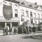 Local people of St. Niklaas, Belgium with members of C Squadron, 44th Battalion Royal Tank Regiment, with Sherman tanks in the background. September 9th 1944