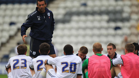 Phil Brown talks to his players after a pre-season friendly.