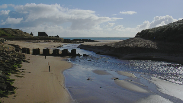 Blue skies looking out over the river and beach at Cruden Bay