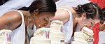 Brides in a cake eating competition