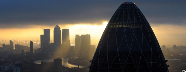 A view of the Gherkin and Canary Wharf at sunrise