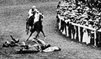 Suffragette Emily Davison throws herself in front of the horse of King George V