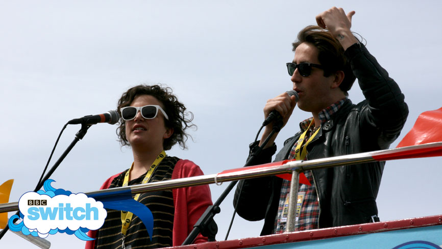 Annie and Nick look over the Big Weekend site from the top of the bus