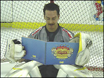 Netminder Curtis Cruickshank reading in the net